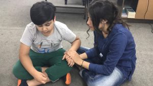 Kurdish Church young girl praying for young boy copy