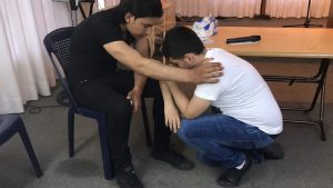 Kurdish church--man praying for another man copy